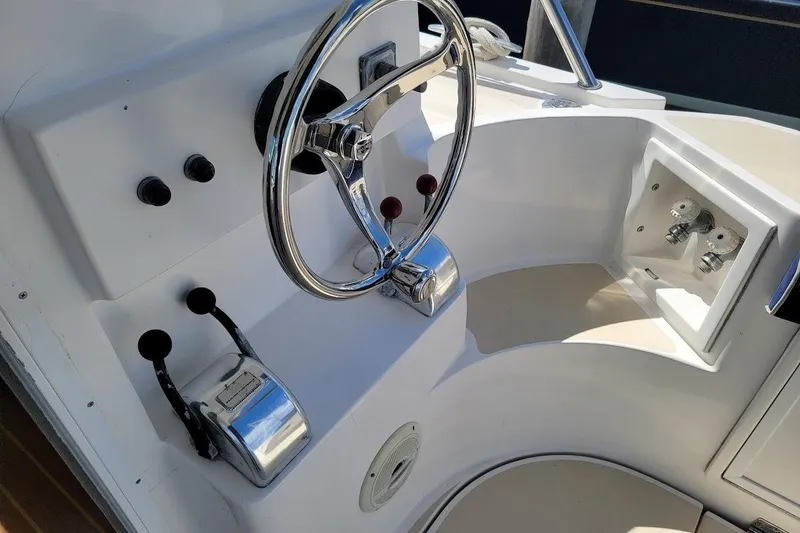 Slide: The Image of Steering console of 2005 Compton 33 Downeast Express HT boat, featuring controls and gauges. - 3