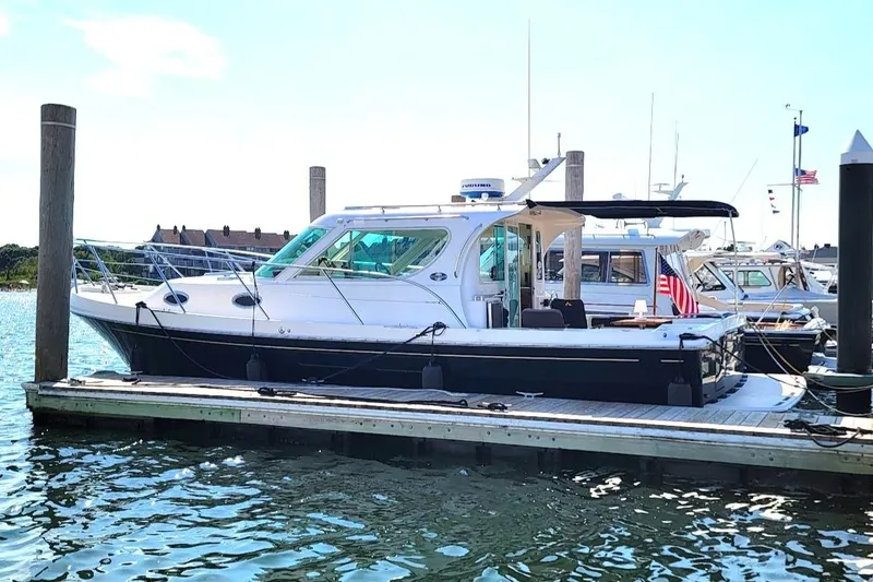 Slide: The Image of 2005 Compton 33 Downeast Express HT yacht docked at marina, sunny day. - 17