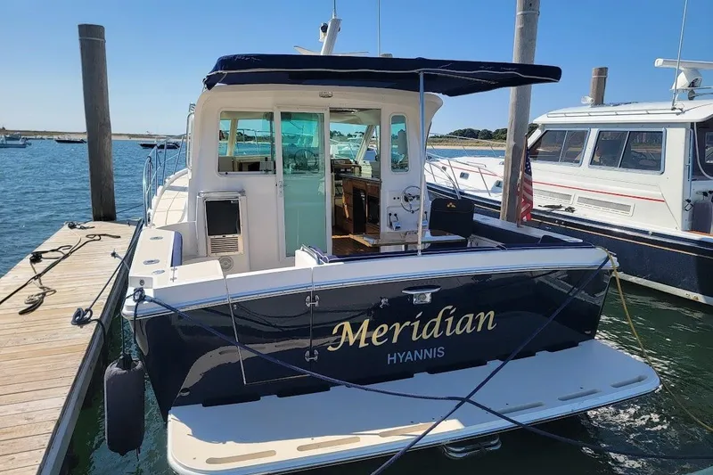 Slide: The Image of 2005 Compton 33 Downeast Express HT boat docked, named "Meridian" in Hyannis marina. - 37