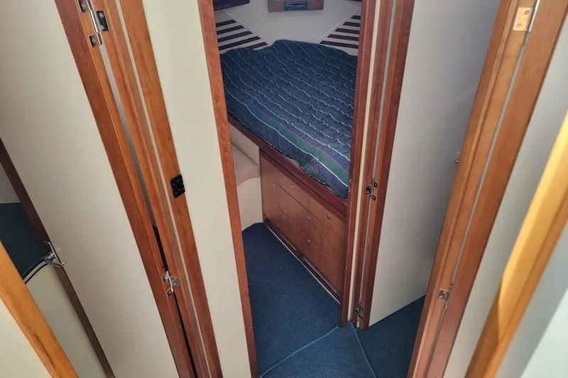 Slide: The Image of Interior cabin of 2005 Compton 33 Downeast Express HT with bed and wooden cabinetry. - 13