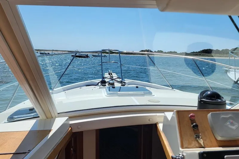 Slide: The Image of 2005 Compton 33 Downeast Express HT cruising on a sunny day, view from helm. - 5