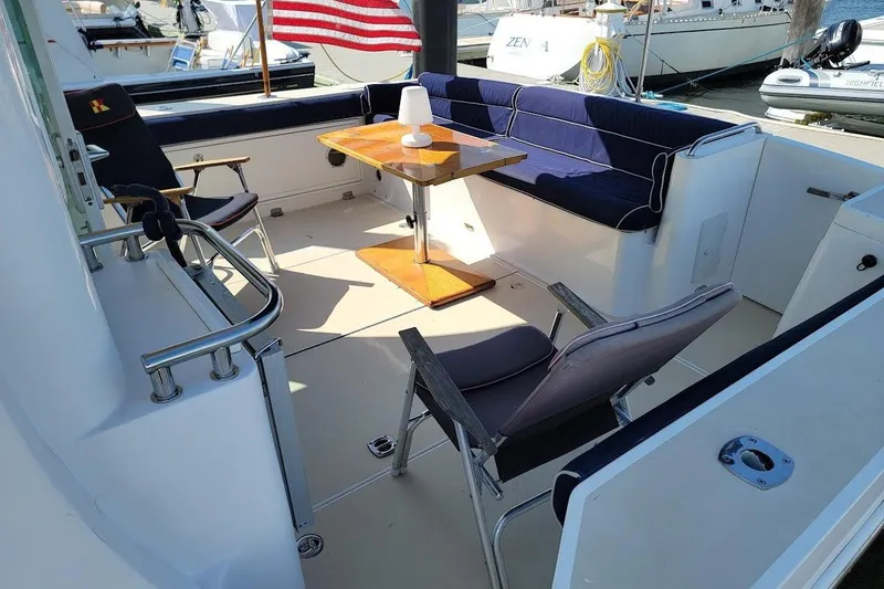 Slide: The Image of 2005 Compton 33 Downeast Express HT boat interior with seating and table. - 2