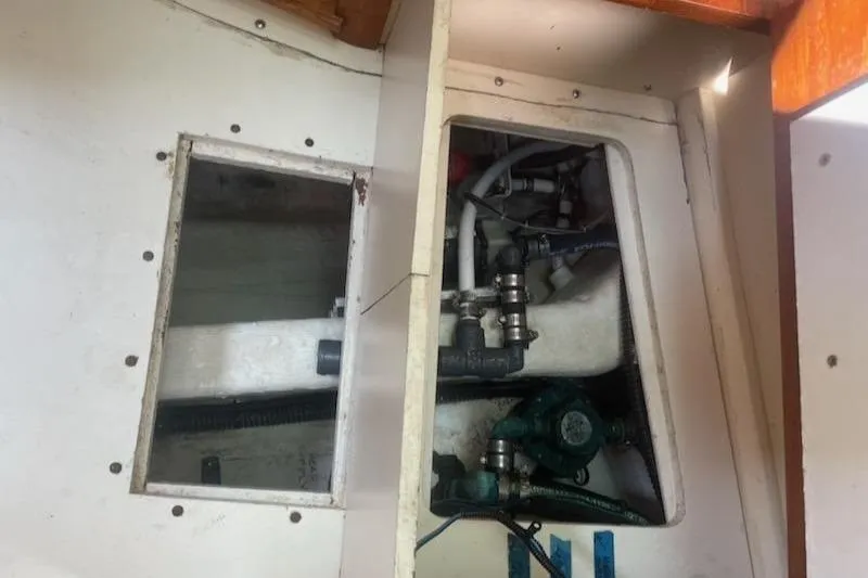 Slide: The Image of Engine compartment of a 2005 Compton 33 Downeast Express HT boat, showing mechanical components. - 20