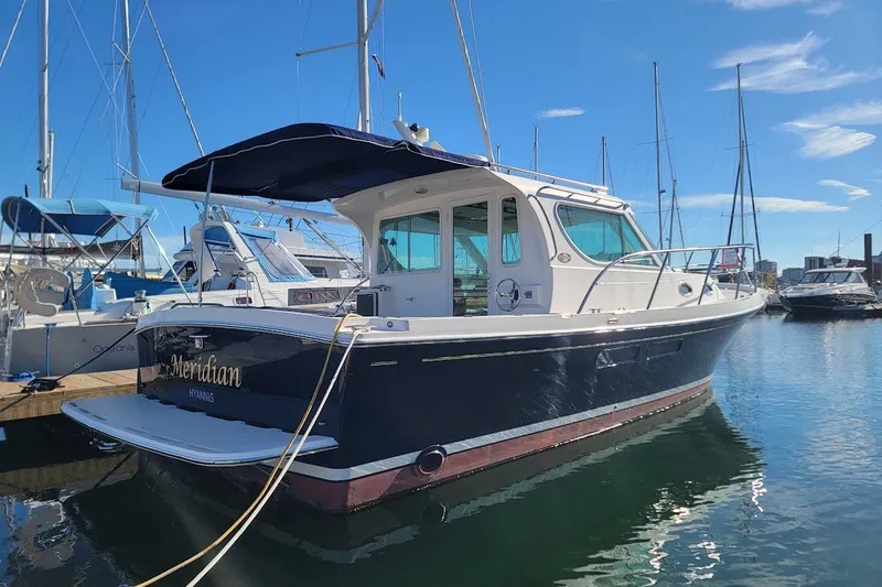Slide: The Image of 2005 Compton 33 Downeast Express HT boat docked in marina under clear blue sky. - 43