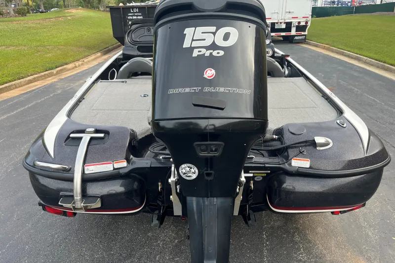Slide: The Image of 2014 Nitro Z-7 boat with 150 Pro Direct Injection engine, parked on a paved road. - 1