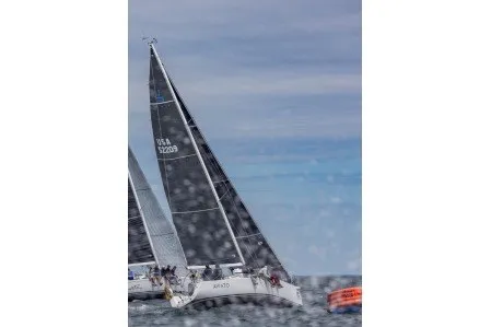 Slide: The Image of 2004 J Boats J/109 sailing in a regatta, with crew on deck and vibrant sails. - 9