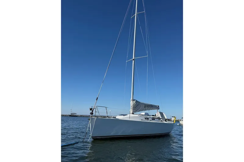 Slide: The Image of 2004 J Boats J/109 sailboat on calm water under clear blue sky. - 3