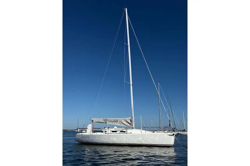 Slide: The Image of 2004 J Boats J/109 sailboat on calm water under clear blue sky. - 6