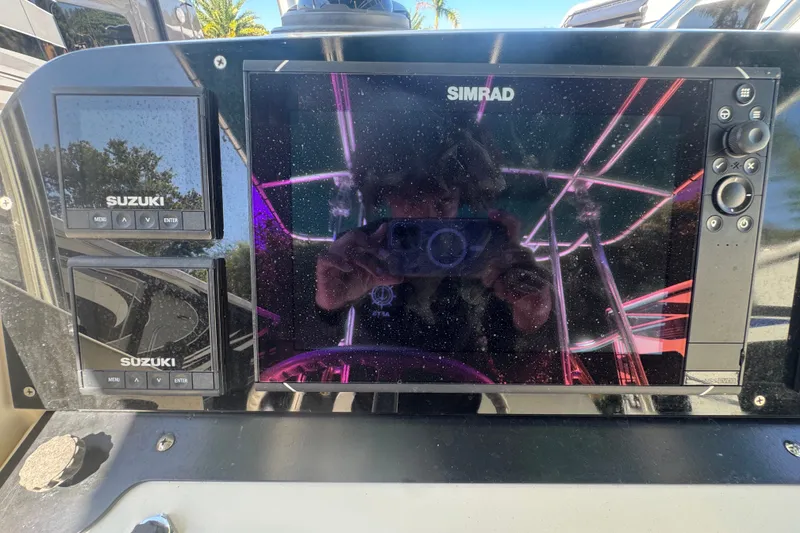 Slide: The Image of Console of 2001 Pursuit 3070 Center Console with Simrad and Suzuki displays. - 30