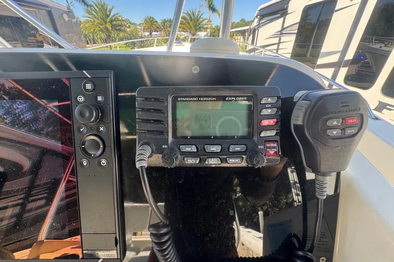 Slide: The Image of Control panel of a 2001 Pursuit 3070 Center Console boat with radio and navigation equipment. - 32
