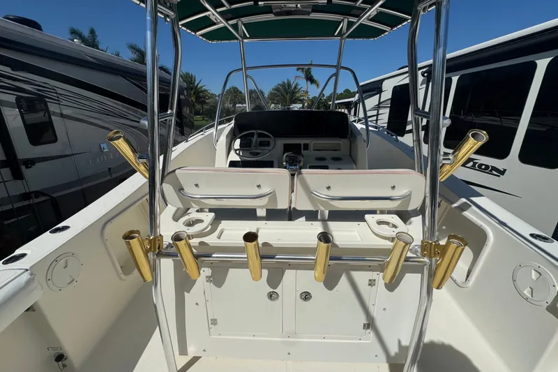 Slide: The Image of 2001 Pursuit 3070 Center Console boat interior with rod holders and steering console. - 16