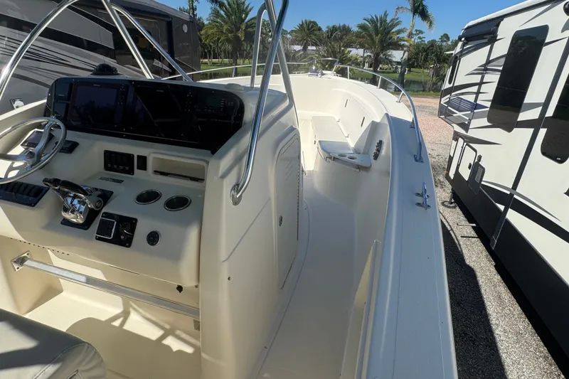 Slide: The Image of 2001 Pursuit 3070 Center Console boat interior with steering wheel and control panel. - 34