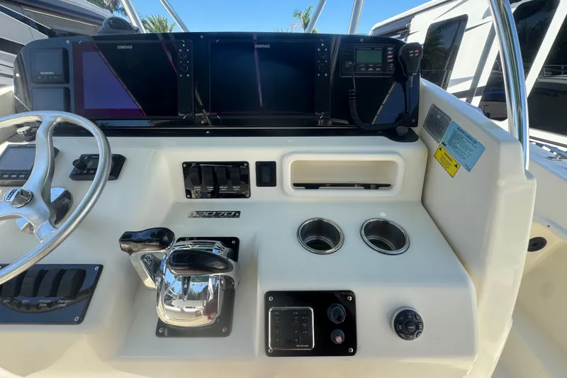 Slide: The Image of Center console of a 2001 Pursuit 3070 boat with navigation equipment and controls. - 26