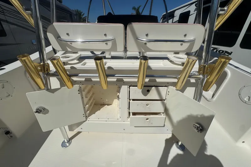 Slide: The Image of 2001 Pursuit 3070 Center Console boat with open storage compartments and rod holders. - 20