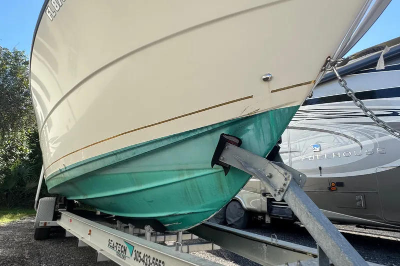 Slide: The Image of 2001 Pursuit 3070 Center Console boat on trailer, parked outdoors. - 52