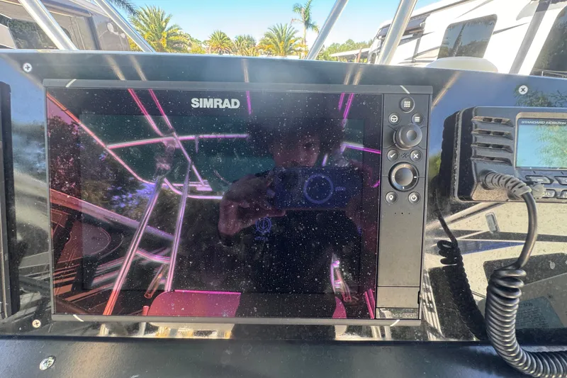 Slide: The Image of Simrad navigation system on 2001 Pursuit 3070 Center Console boat dashboard. - 31