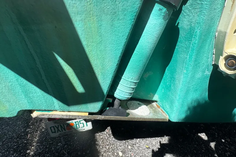 Slide: The Image of Close-up of a 2001 Pursuit 3070 Center Console boat hull and license plate. - 64