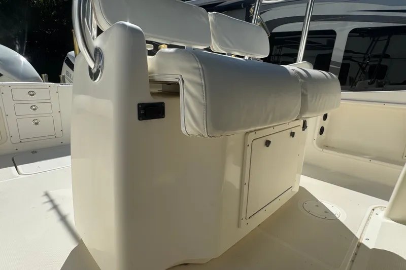 Slide: The Image of 2001 Pursuit 3070 Center Console boat interior with white seating and storage compartments. - 21