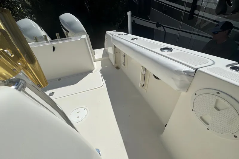 Slide: The Image of 2001 Pursuit 3070 Center Console boat interior with seating and storage compartments. - 13