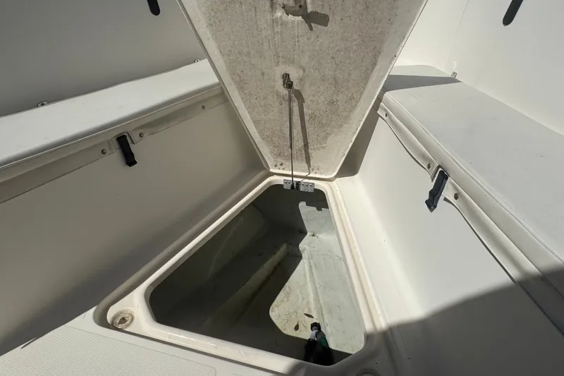 Slide: The Image of Open storage compartment on a 2001 Pursuit 3070 Center Console boat. - 47
