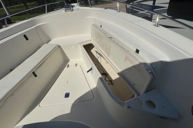 Slide: The Image of 2001 Pursuit 3070 Center Console boat interior with open storage compartment. - 45