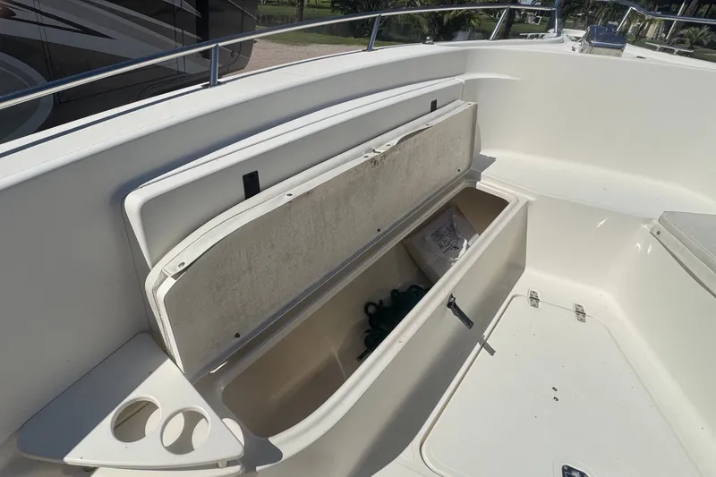 Slide: The Image of The 2001 Pursuit 3070 Center Console features a spacious storage compartment with cup holders. - 44