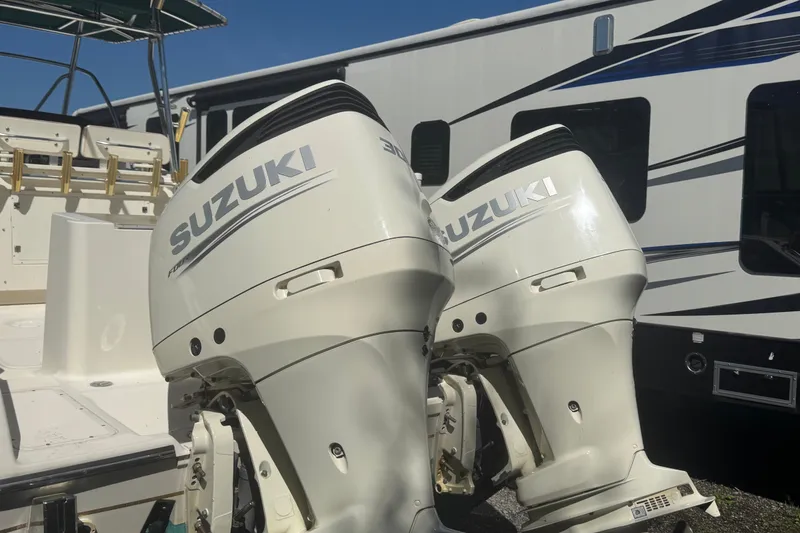 Slide: The Image of Twin Suzuki outboard motors on a 2001 Pursuit 3070 Center Console boat. - 56