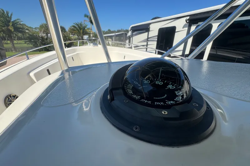 Slide: The Image of Compass on 2001 Pursuit 3070 Center Console boat, with clear blue sky background. - 33