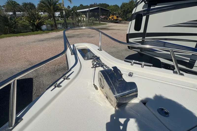 Slide: The Image of Bow of a 2001 Pursuit 3070 Center Console boat with anchor chain and railing. - 49