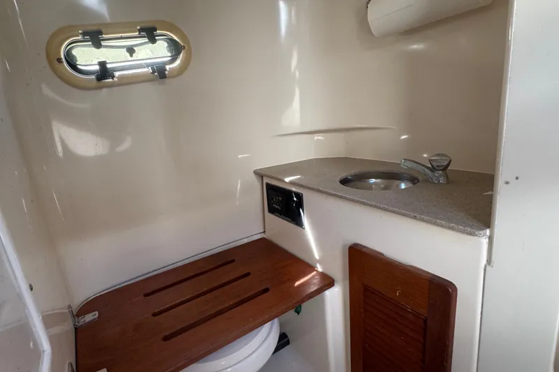 Slide: The Image of 2001 Pursuit 3070 Center Console boat interior with sink and toilet. - 37
