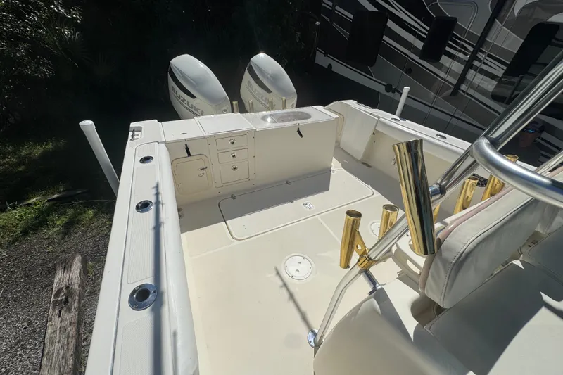 Slide: The Image of 2001 Pursuit 3070 Center Console boat deck with dual Suzuki outboard motors. - 17