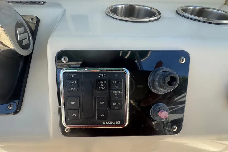 Slide: The Image of Control panel of a 2001 Pursuit 3070 Center Console boat with Suzuki controls. - 28