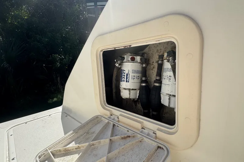 Slide: The Image of Fuel filters in a 2001 Pursuit 3070 Center Console boat compartment. - 55