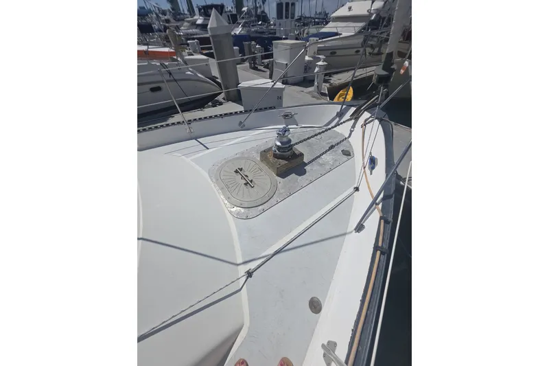 Slide: The Image of 1981 Lancer Motor Sailer deck with winch, docked at marina. - 22
