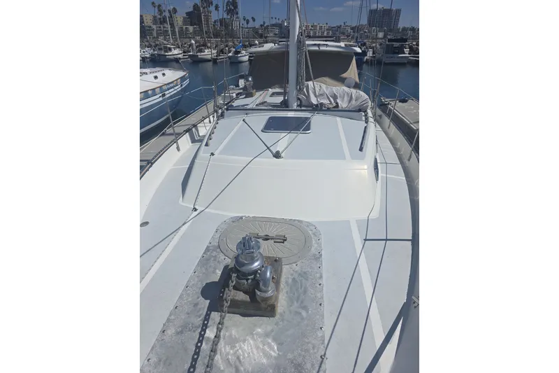 Slide: The Image of 1981 Lancer Motor Sailer deck view in marina, showcasing sleek design and moored boats. - 23