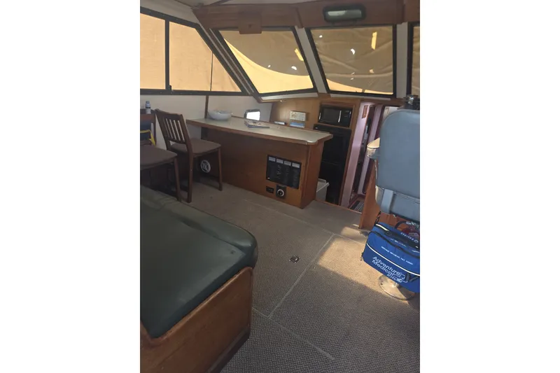 Slide: The Image of Interior of 1981 Lancer Motor Sailer with seating, table, and navigation equipment. - 18