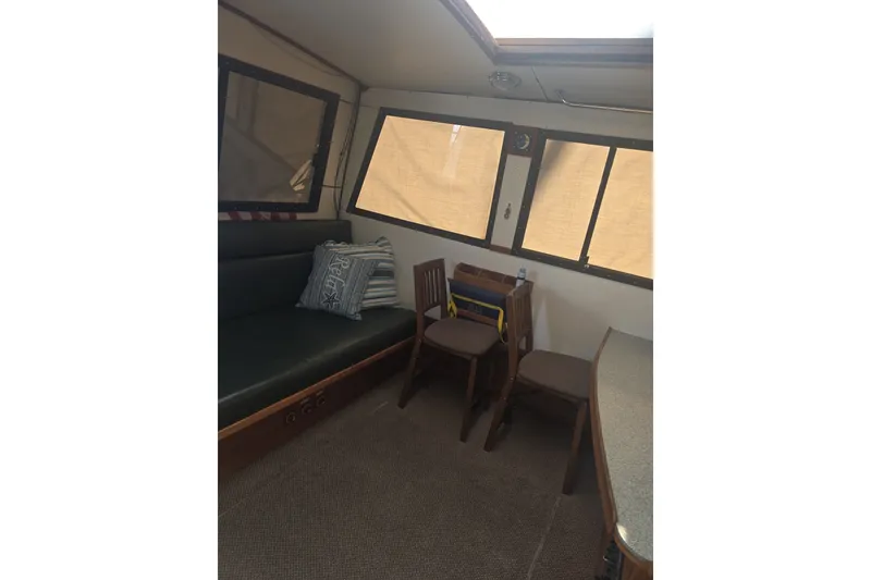Slide: The Image of Interior of 1981 Lancer Motor Sailer with seating, windows, and nautical decor. - 19