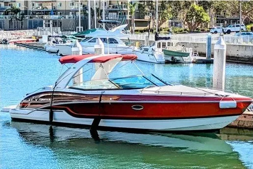 The Image of 2019 Formula 310 Bowrider boat docked in a marina with red accents. - 0