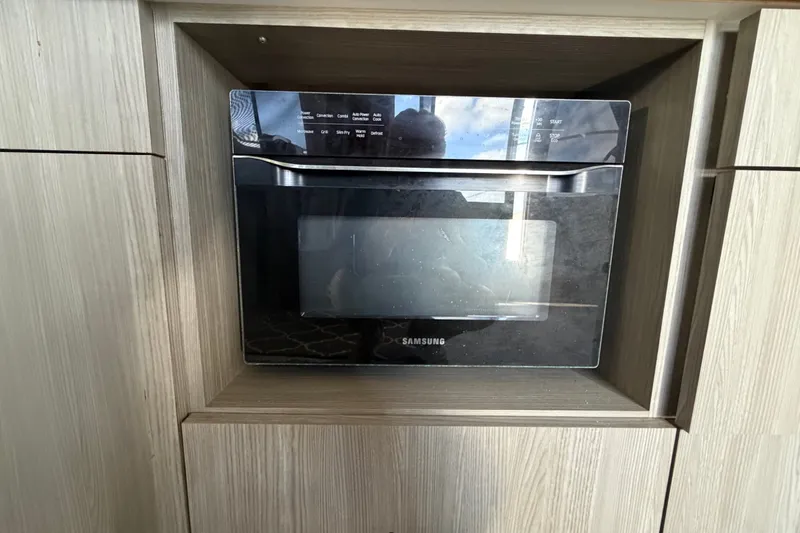 Slide: The Image of Built-in Samsung microwave in Bluewater Yachts Coastal Cruiser 51, 1987 model. - 58