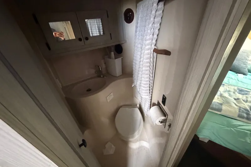 Slide: The Image of 1987 Bluewater Yachts Coastal Cruiser 51 bathroom with sink, toilet, and towel rack. - 46