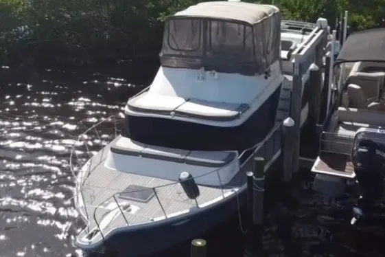 Slide: The Image of 1987 Bluewater Yachts Coastal Cruiser 51 docked on a sunny day. - 5