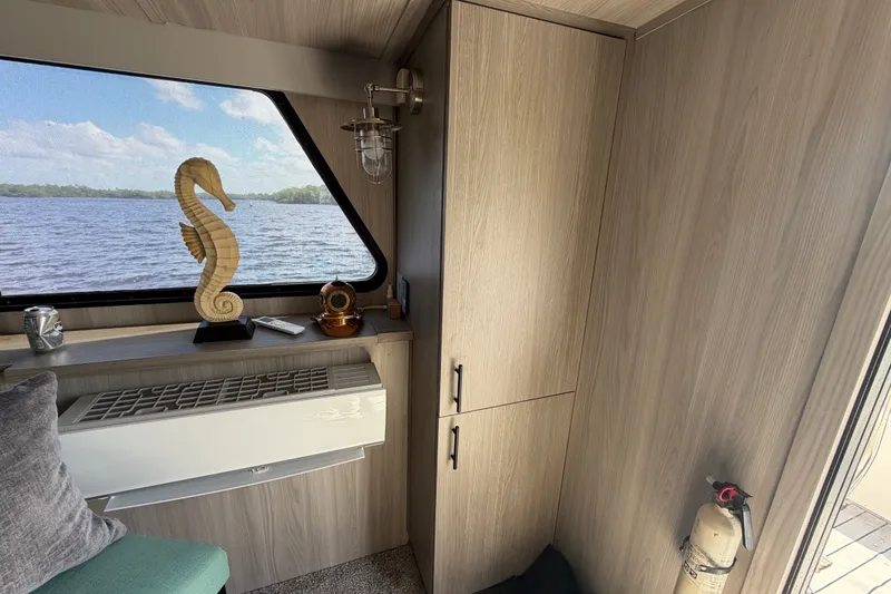 Slide: The Image of Interior of 1987 Bluewater Yachts Coastal Cruiser 51 with seahorse sculpture and scenic window view. - 29