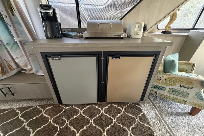 Slide: The Image of Interior of 1987 Bluewater Yachts Coastal Cruiser 51 with kitchenette and appliances. - 55