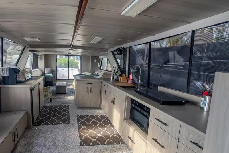 Slide: The Image of Interior of 1987 Bluewater Yachts Coastal Cruiser 51, featuring modern kitchen and seating area. - 3