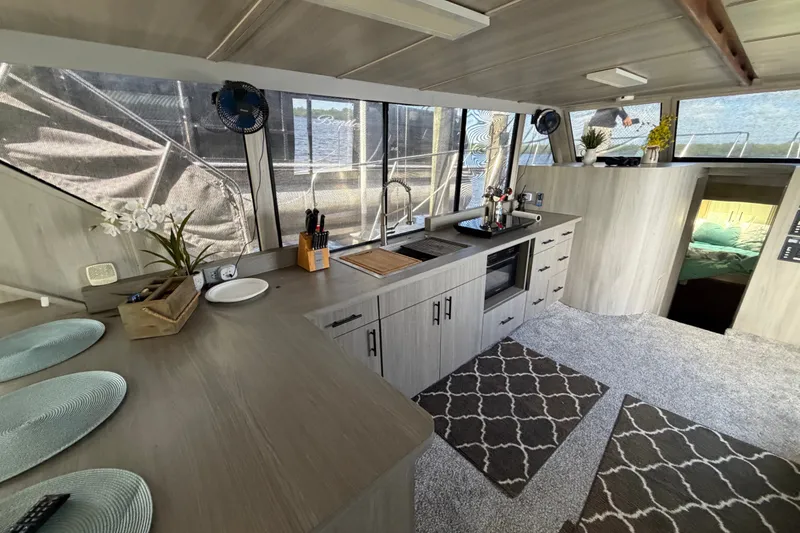 Slide: The Image of Interior of 1987 Bluewater Yachts Coastal Cruiser 51 with modern kitchen and cozy decor. - 36
