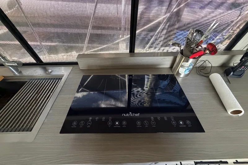 Slide: The Image of Modern kitchen setup on 1987 Bluewater Yachts Coastal Cruiser 51 with induction cooktop. - 41