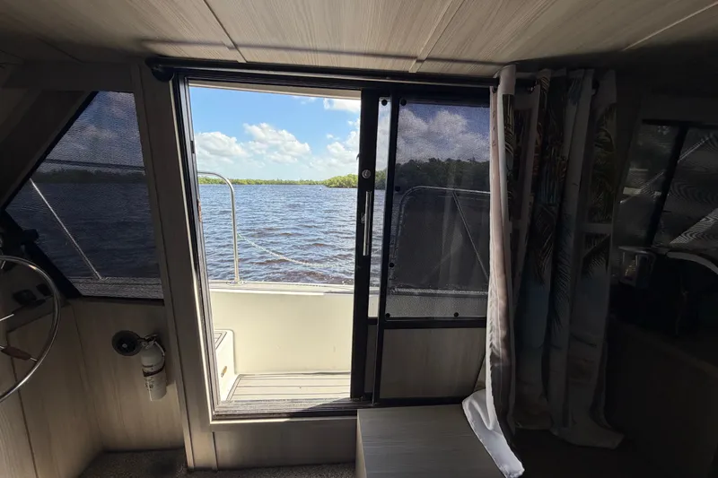 Slide: The Image of Interior view from 1987 Bluewater Yachts Coastal Cruiser 51, overlooking serene water and sky. - 49