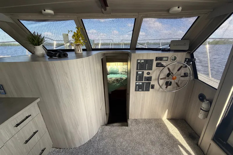 Slide: The Image of 1987 Bluewater Yachts Coastal Cruiser 51 interior helm with steering wheel and control panels. - 42