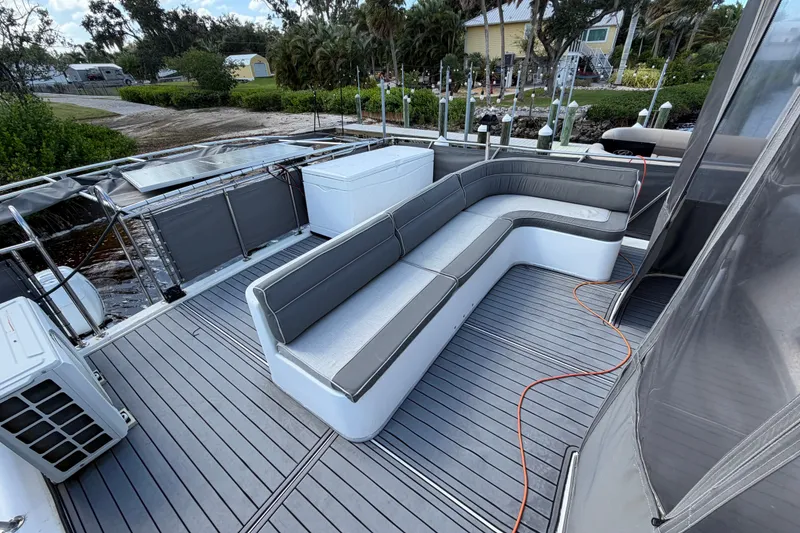 Slide: The Image of 1987 Bluewater Yachts Coastal Cruiser 51 deck with gray seating and outdoor amenities. - 51