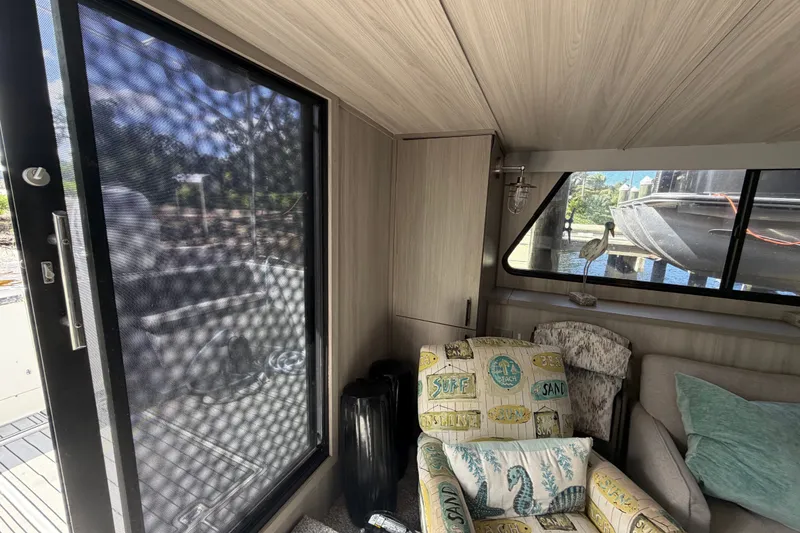 Slide: The Image of Interior of 1987 Bluewater Yachts Coastal Cruiser 51 with cozy seating and decorative pillows. - 30